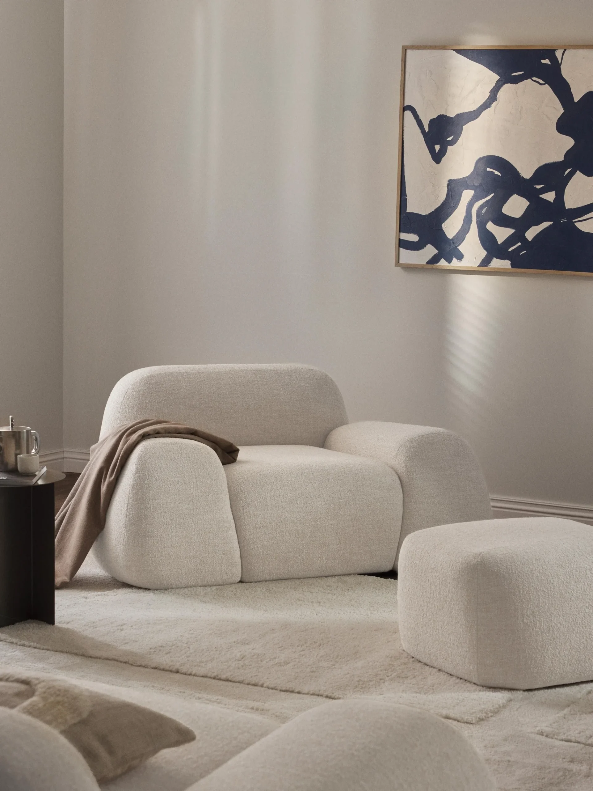 The Corduroy Armchair is a refined blend of modern minimalism and inviting comfort. Upholstered in textured fabric with a soft neutral tone, its square silhouette and plush cushion make it both stylish and functional