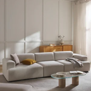 The Melva Sofa (4-Seater) is a spacious and stylish centerpiece for modern interiors. Upholstered in soft, neutral-toned fabric, it features rounded armrests, plush cushions, and a clean low-profile silhouette that emphasizes both comfort and sophistication