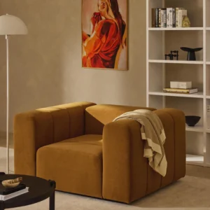 LENA velvet lounge chair with extra-deep seat, flowing lines, and soft upholstery. Compact modern design crafted in the UAE.