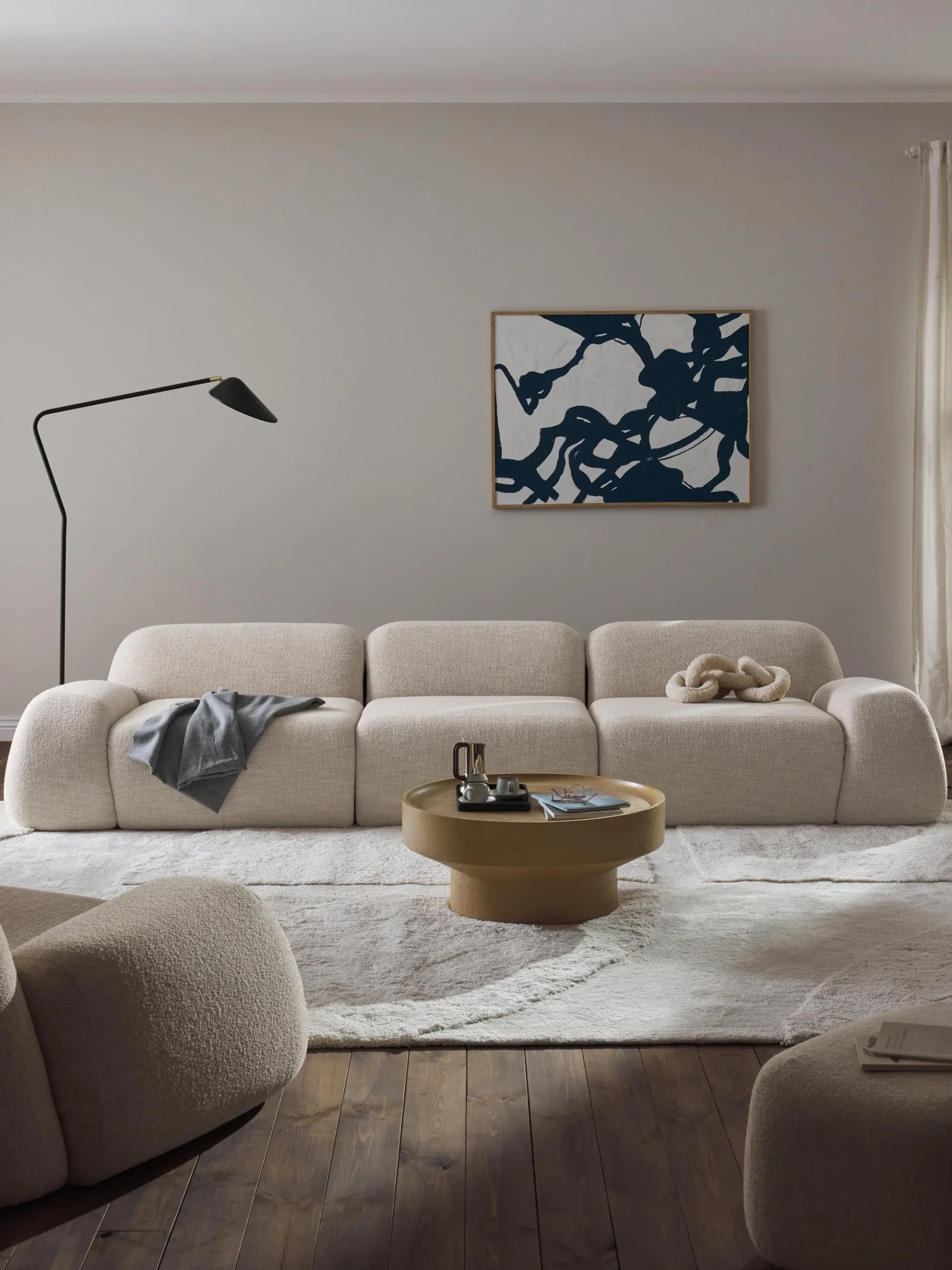 The Wolke Modular Bouclé Sofa (4-Seater) embodies contemporary elegance with its sculptural form and inviting texture