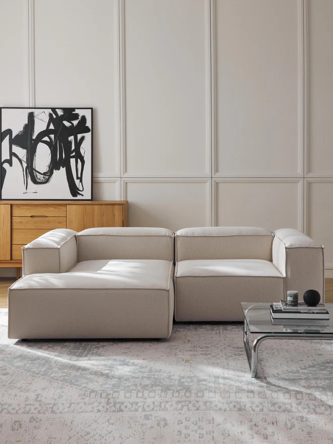 The LANA console not only offers additional storage space but is also a decorative highlight that fits the LENNON dimensions perfectly. The LENNON ottoman with a wooden top can be used either as a coffee table or as a connecting element for the sofa—for a stylish look, storage, and practical use.