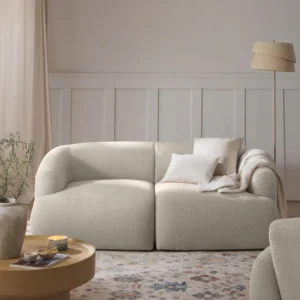 SOFIA 2-seater modular sofa in off-white bouclé with rounded organic silhouette, firm foam seating, and FSC-certified wood frame, shown frontally.