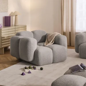 TAYLA – Bouclé lounge chair with bubble-inspired design and soft backrest. A modern statement piece made in Europe, offering elegance, comfort, and inviting style for any living space.Tayla lounge chair in bouclé fabric featuring rounded bubble-style upholstery, soft cushioned backrest, and contemporary design
