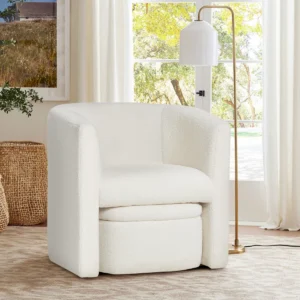Arden upholstered barrel accent chair with flared arms and hidden storable ottoman, upholstered in bouclé or velvet for comfort and modern style.