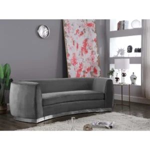 Luxurious curved velvet 4-seater sofa with gold stainless steel base and plush seating in a modern living room setting