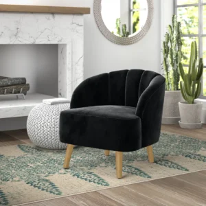Velvet mid-century accent chair with curved back, channel stitching, and wooden legs in a modern living room setting.
