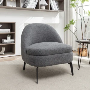 Bouclé upholstered barrel accent chair with curved armless design and black metal legs in a contemporary living space.
