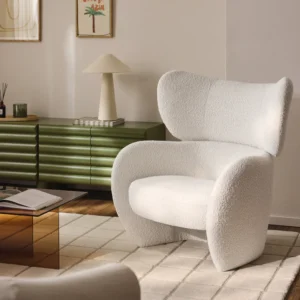Teyvat armchair with organic shape and high backrest, upholstered in soft fabric, available in multiple colors for cozy everyday relaxation