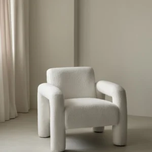 Cloud armchair with curved contemporary design, upholstered in neutral bouclé fabric, creating a versatile and stylish centerpiece