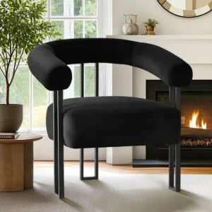 Chocolate brown velvet armchair with round arms, tripod black metal legs, and tight back design