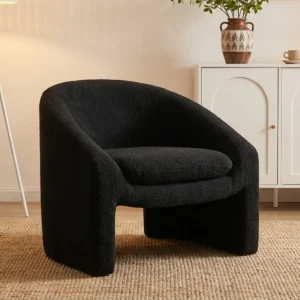 Liora Upholstered Barrel Accent Chair with rounded silhouette, bouclé fabric, flared arms, and sled base in a modern living room setting