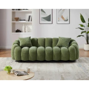 Green modular sofa with curved petal-shaped armrests and plush cushioned seating in modern living room setting