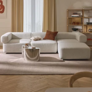 Anton modular 4-seater bouclé sofa with brushed metal details and a flexible ottoman that can be positioned left, right, or used standalone, designed for customizable layouts