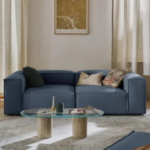 Modern LENNON modular sofa with low-profile design, deep seating, and customizable sections paired with matching ottoman and console in a contemporary living room.