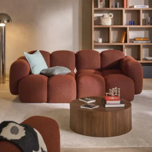 Modern TAYLA sofa with rounded bubble-style upholstered design, plush cushioning, and sculptural silhouette in a stylish living room.