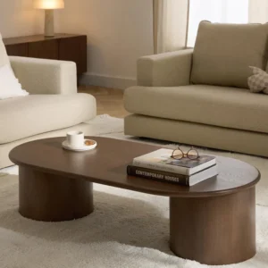 Oval Didi coffee table in solid oak wood with organic oval shape and wide round legs, available in natural, dark brown, or black finishes