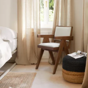 SISSI armchair with upholstered seat and back, inspired by Pierre Jeanneret’s 1950s design, blending modern aesthetics with timeless craftsmanship. Each piece unique due to natural materials