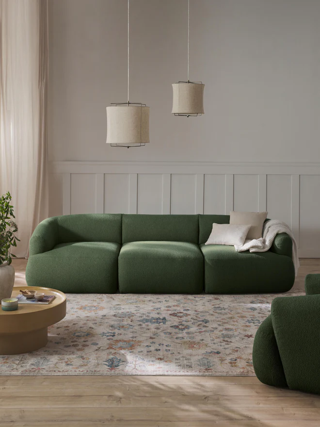SOFIA modular sofa with rounded organic shapes and matching cushions in a stylish contemporary living room setting.