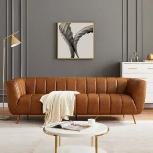 Modern 3-seater genuine leather sofa with tuxedo arms, channel-tufted back, and gold metal legs in a sleek contemporary design.