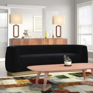 Curved velvet sofa with gold stainless steel base, rounded arms, and modern sculptural design in a luxurious style.