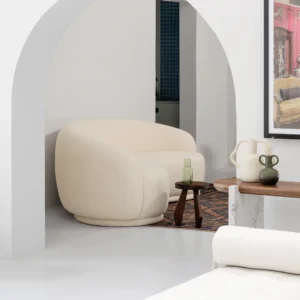 Lola Curved Sofa with gently curved frame, refined lines, deep cushioned seating, and supportive backrest, styled in a modern living room