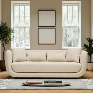 Front view of Altura 3-Seater Sofa in white sand-textured upholstery with rounded cushioned frame, built-in lumbar support, throw pillows, and charcoal wooden legs, blending modern comfort with mid-century-inspired design