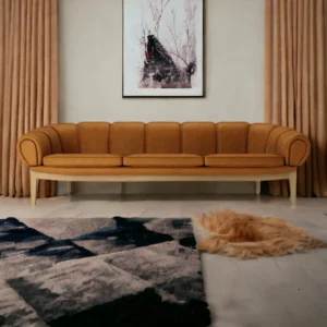 Front view of Nismaaya Adaya 3 Seater Sofa in premium brown fabric with deep cushioned seating, sturdy wooden frame, and elegantly carved legs, showcasing traditional design and luxurious comfort