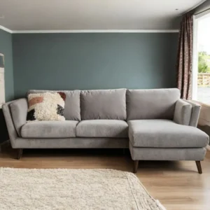 Coventry corner sofa with right-hand facing chaise in light grey velvet, featuring mid-century wooden legs and elegant design